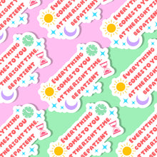 Load image into Gallery viewer, A collage of stickers with the following quote &quot;everything comes to you at the right time. Be patient&quot;. the sticker has stars sprinkled around, a depiction of the sun and moon on one side and a classic clock and an hour glass on the other side
